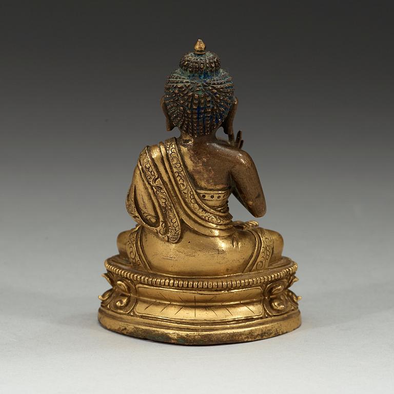 A partly gilt Tibeto-Chinese figure of Maitreya Buddha, 18th century.