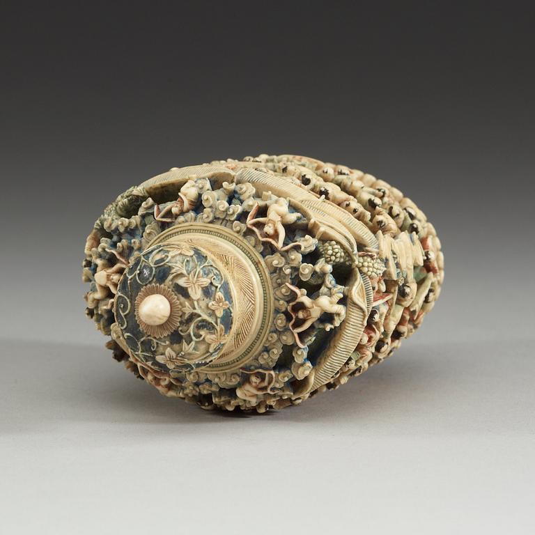 A deeply carved ivory snuff bottle with cover, China, early 20th Century.