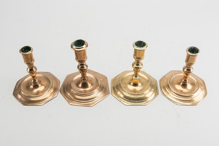 A set of four late Baroque brass candlesticks.