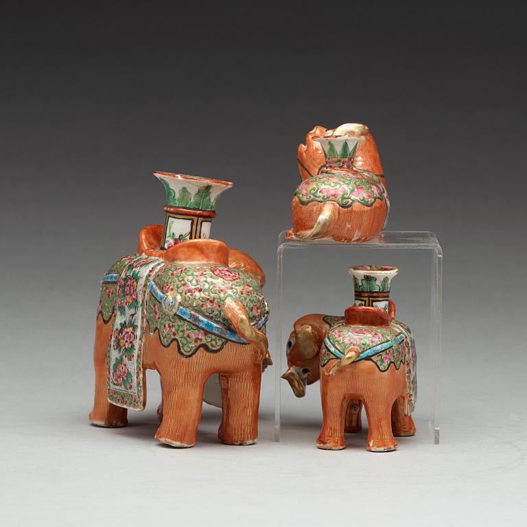 A group of Canton famille rose candle sticks, late Qing dynasty, early 20th Century.