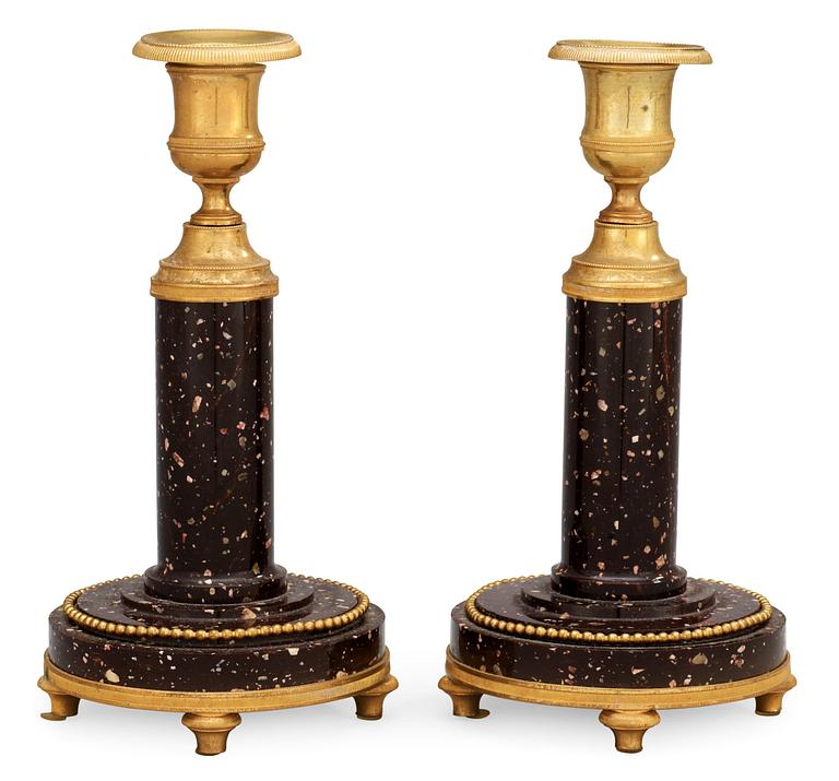 A pair of late Gustavian circa 1800 porphyry and gilt bronze candlesticks.