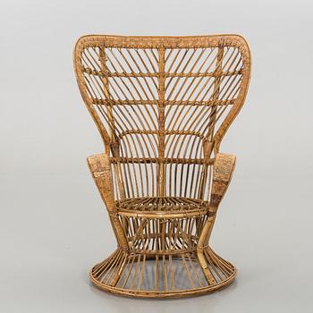 A RATTAN ARMCHAIR.