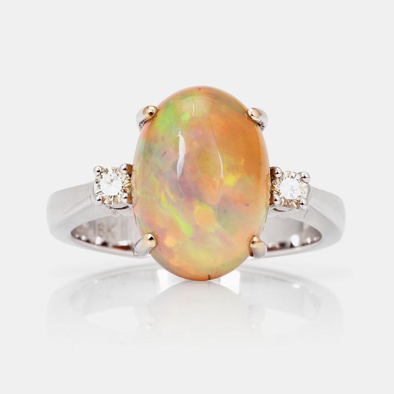 An opal and brilliant-cut diamond ring.