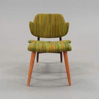 An IKEA armchair with a stool.