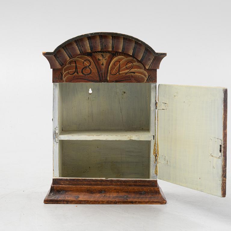 A pianted wall cabinet, dated 1812..
