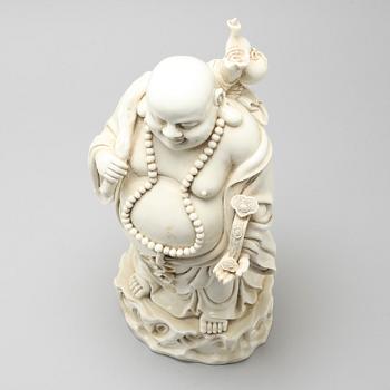 A blanc de Chine porcelian figurine of buddai, 20th Century.