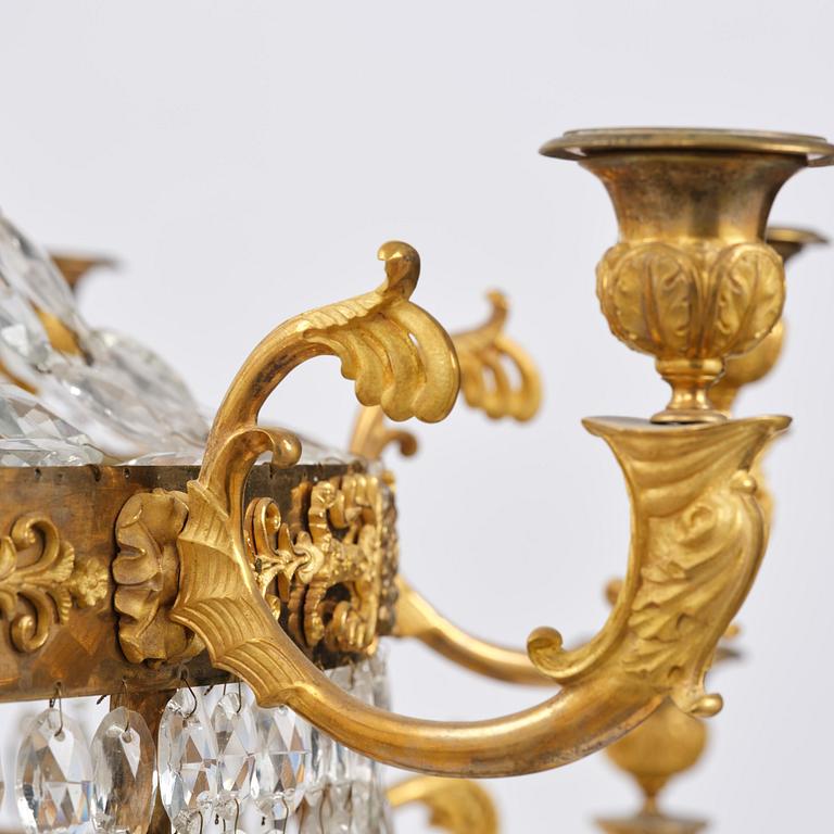 An ormolu and cut glass sixteen-branch Empire chandelier, Paris, early 19th century.