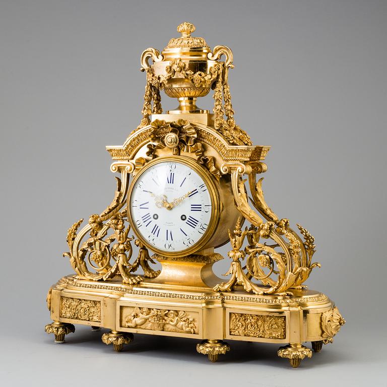 A Louis XVI-style late 19th century gilt bronze mantel clock.