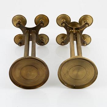 A pair of brass candelabras, first half of the 20th century.