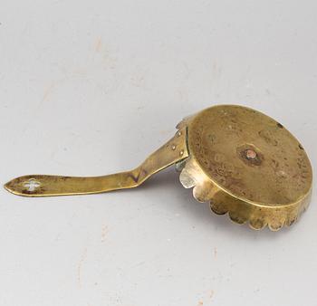 An English 18th century brass night light holder.