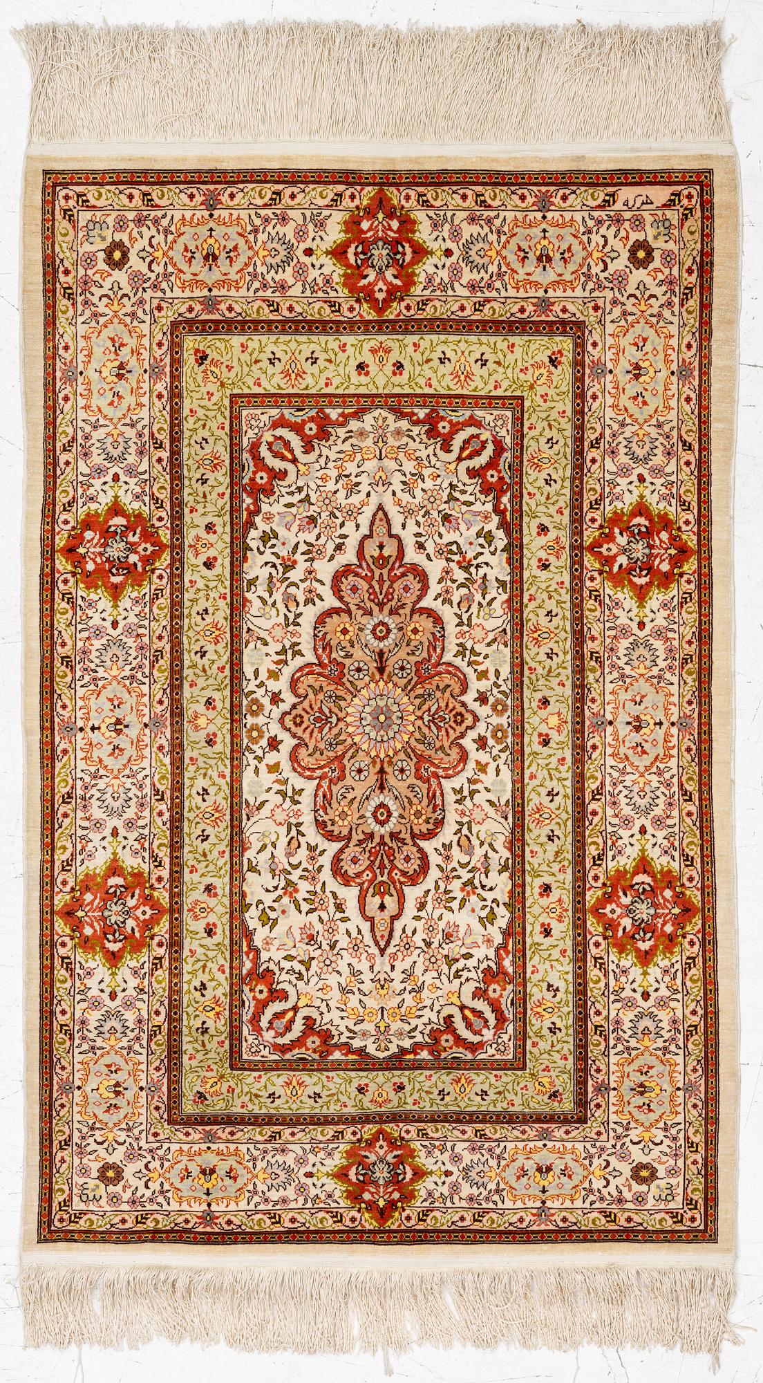A Hereke silk rug, West Anatolia, c. 107 x 69 cm.
