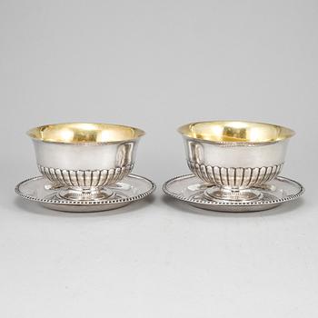 A pair of Swedish 19th century parcel-gilt silver sauce-bowls and plats, marked JP Gronvall, Stockholm 1835.