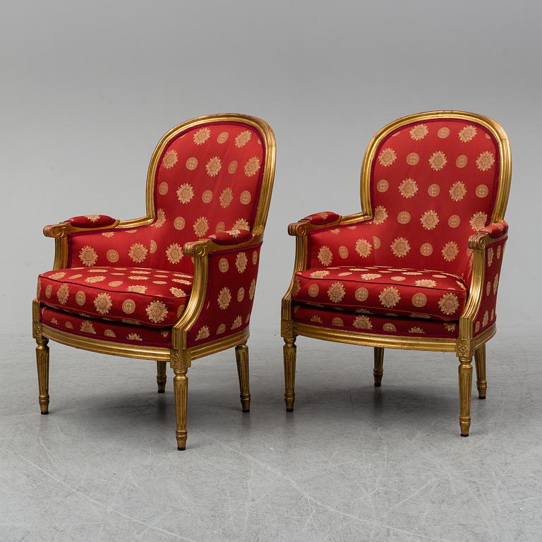 A pair of Louis XVI-style armchairs.