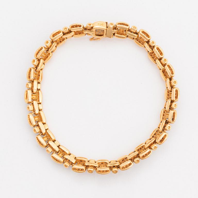 An 18K gold and white gold bracelet set with round brilliant-cut diamonds.