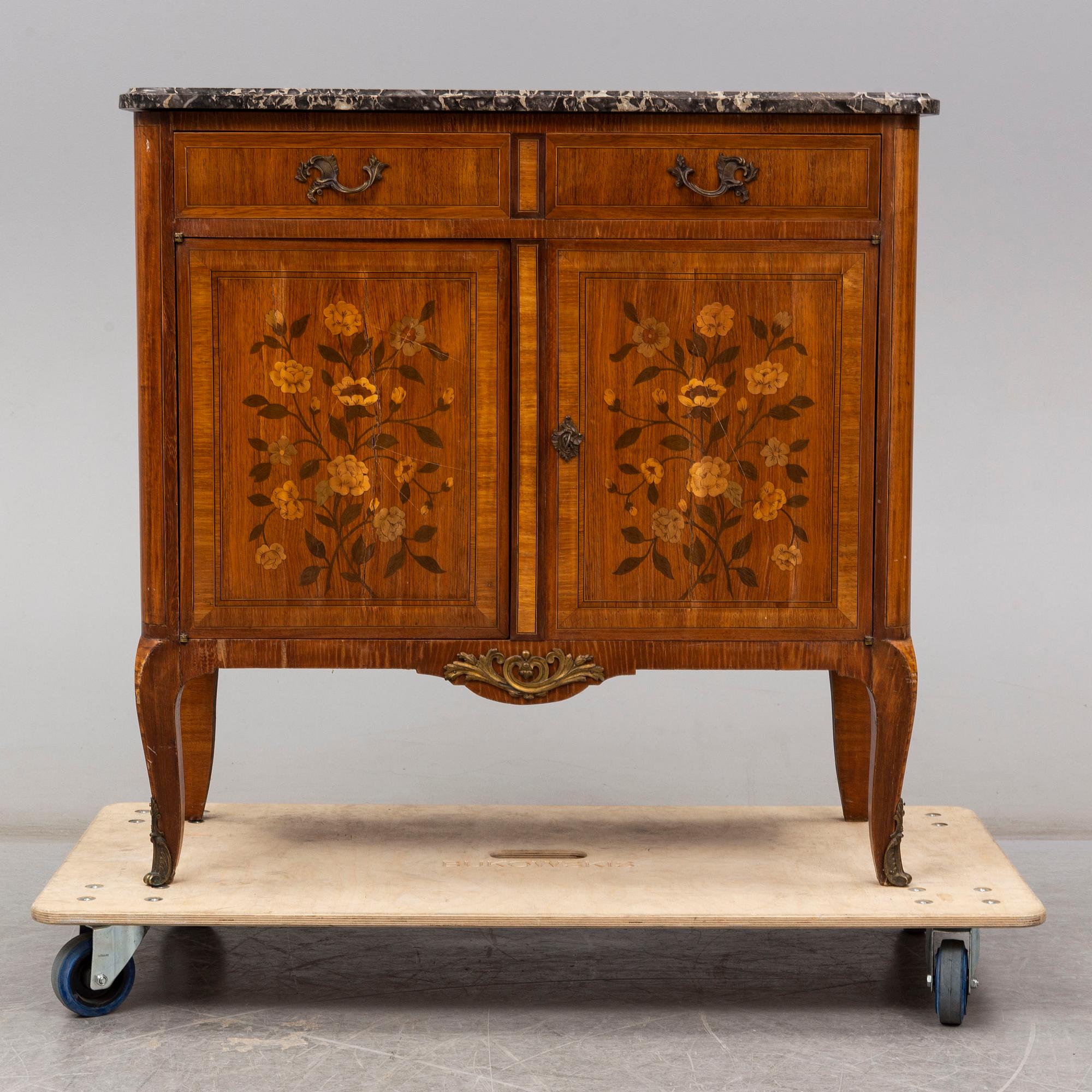 A French Louis XVI-style cupboard, ca 1900.