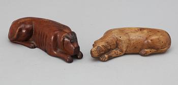 Two 19th-20th century birch snuffboxes in the shape of lying dogs.