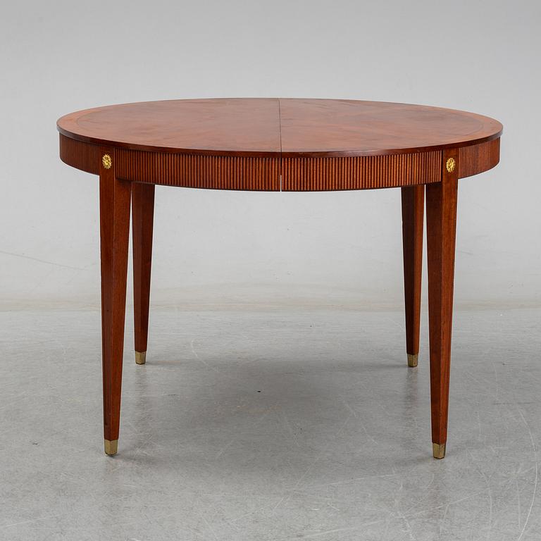 A gustavian style mahogany dining table from the mid 20th century.