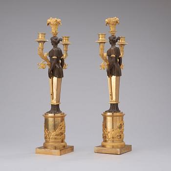 A pair of Empire early 19th century three-light candelabra.