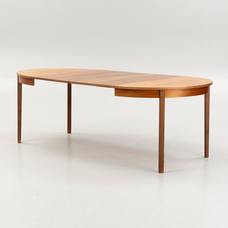 A walnut-veneered dining table, 1960's/70's.