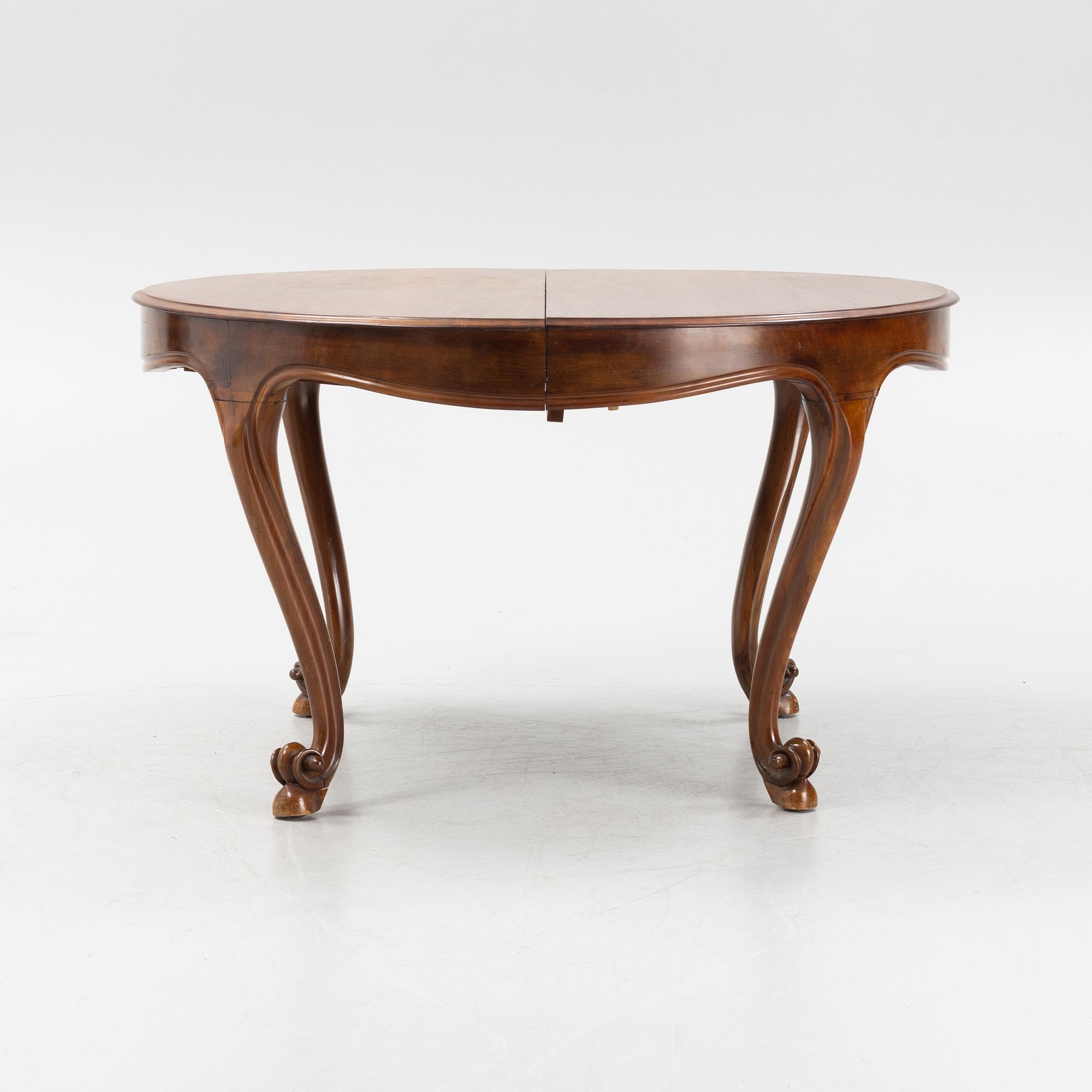 A mahogany rococo style dining table, 19th Century.
