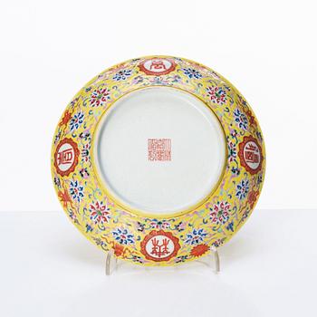 A Chinese famille rose yellow ground 'bat' dish, Qing dynasty with Jiaqing mark.