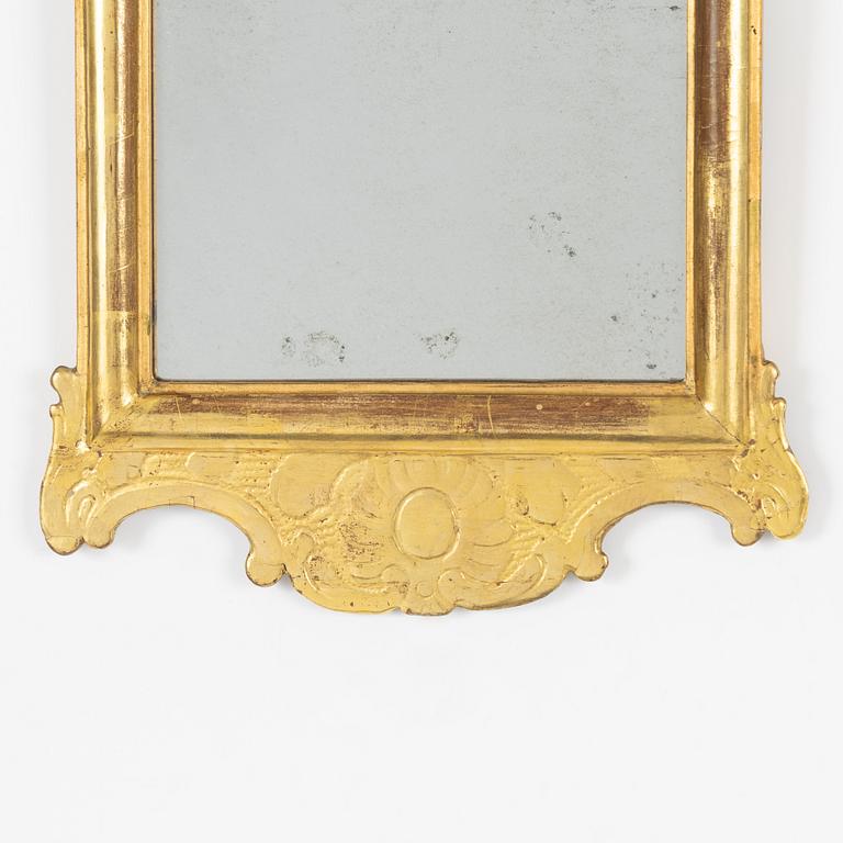A giltwood rococo mirror by J. Schürer (master in Stockholm 1769).