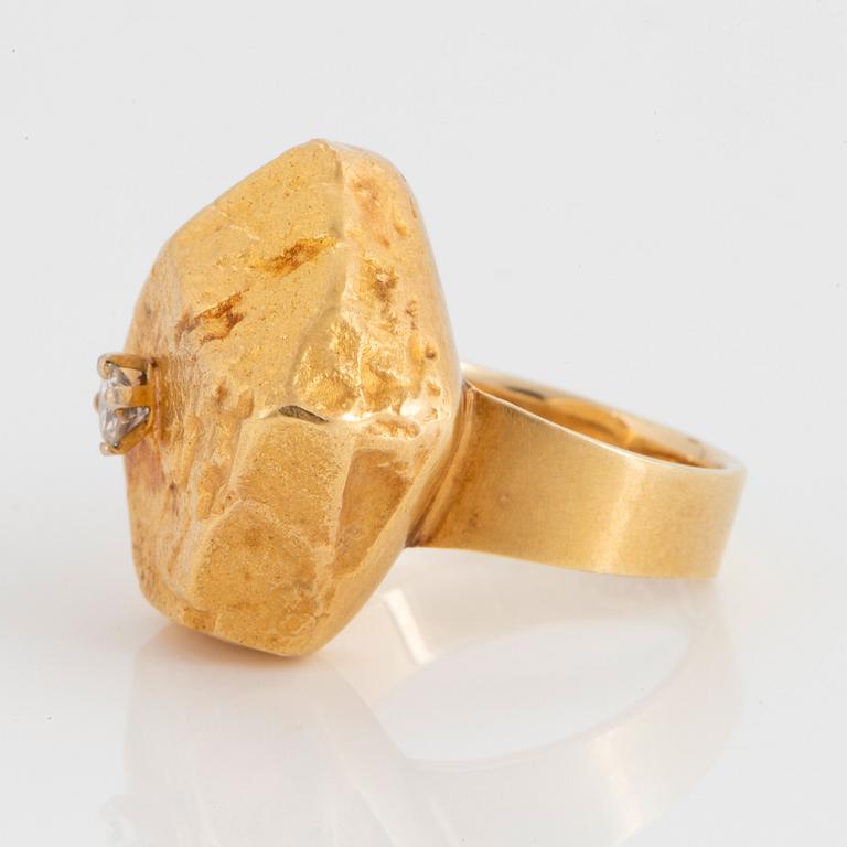 A 14K gold ring set with a round brillant-cut diamonds, made by a part of a Lapponia bracelet.