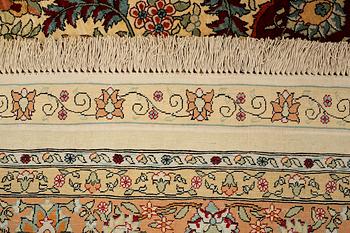 A rug, semi-antique, silke Hereke, signed, ca 184,5 x 118 cm.