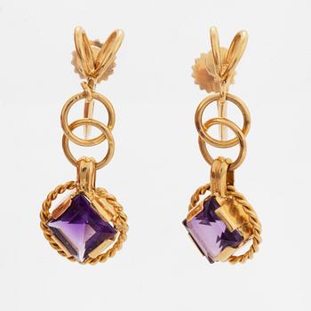 A pair of earrings and a brooch.