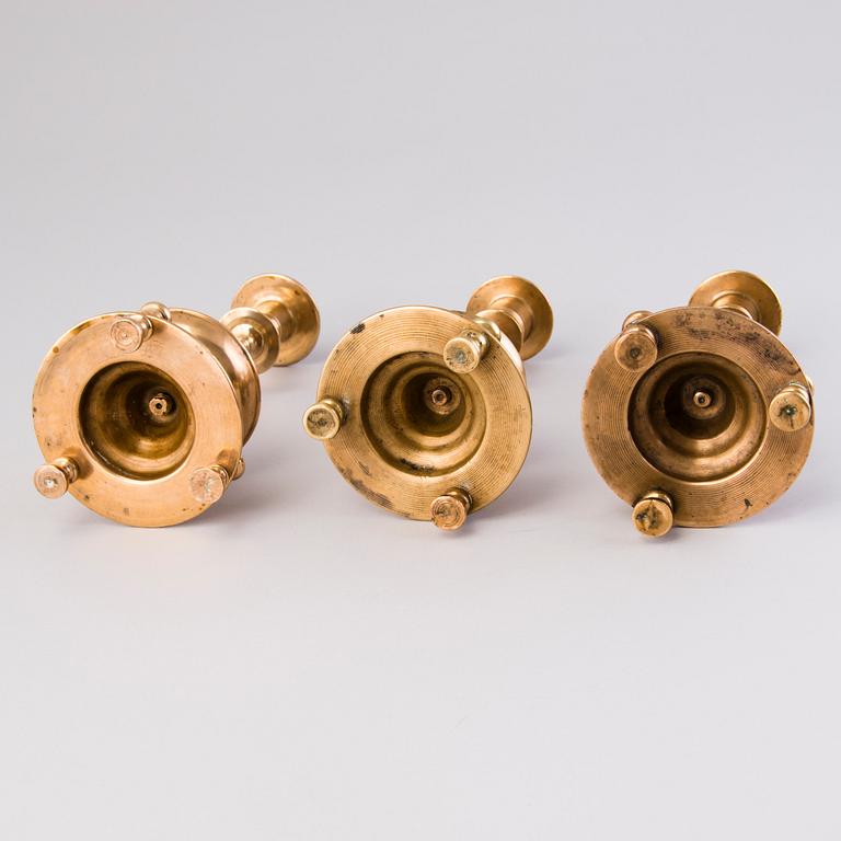 Three Russian brass candlesticks from the end of the 19th and the early 20th Century.