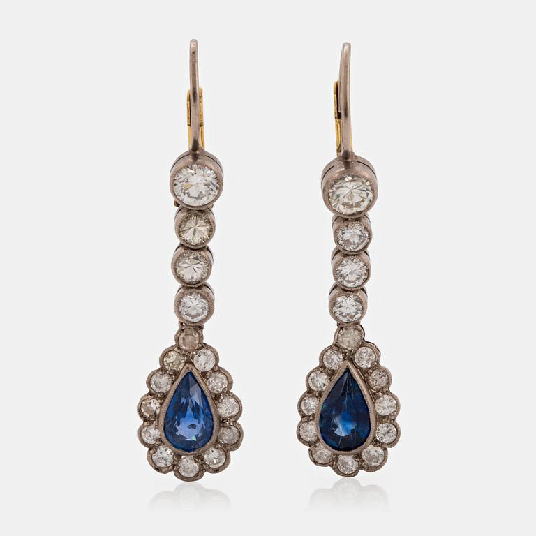 A pair of platinum and 14K gold earrings set with faceted sapphires and old-cut diamonds.