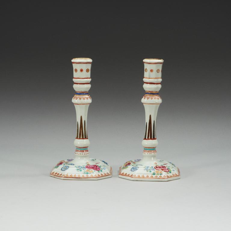 A pair of famille rose candle sticks, Qing dynasty, Qianlong (1736-95).