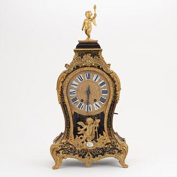 A 19th century rococo style clock, and a 18th century rococo console.