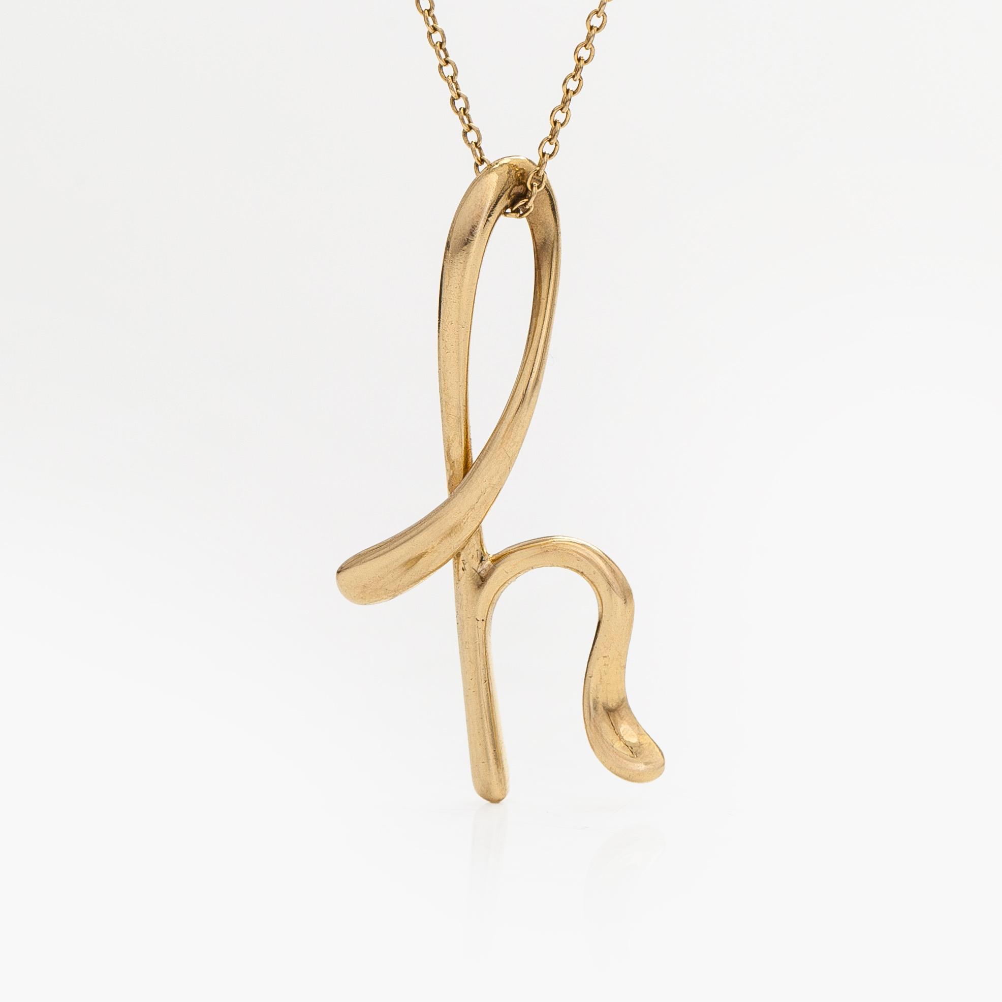 Tiffany & Co, Elsa Peretti, an 18K gold 'Alphabet Pendant' necklace.
