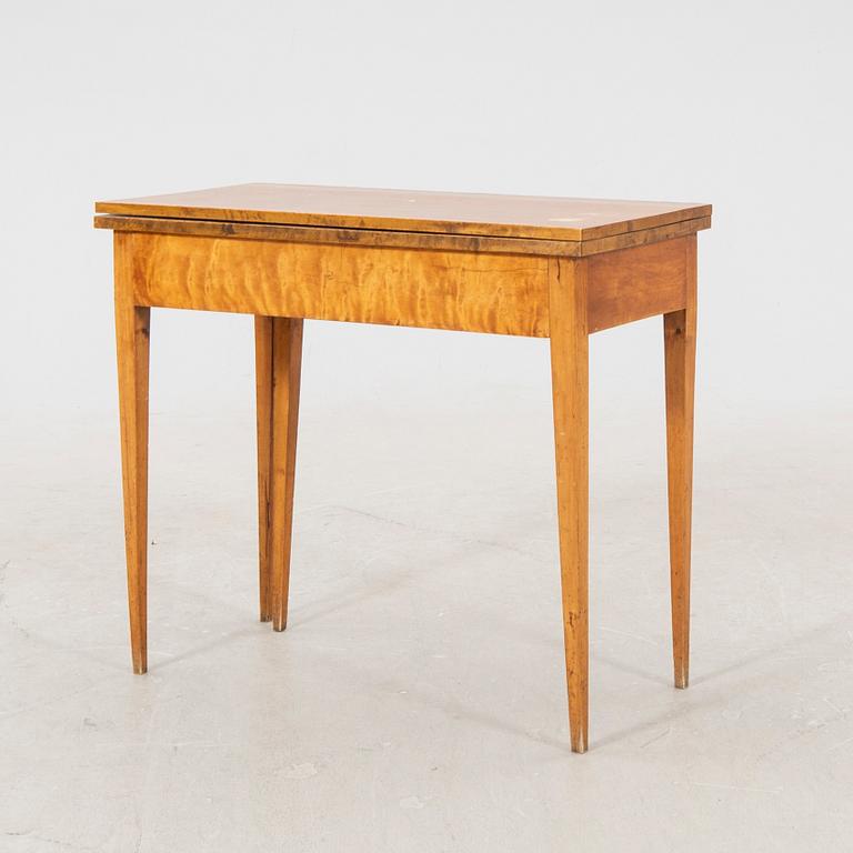 An earluy 1900s birch game table.