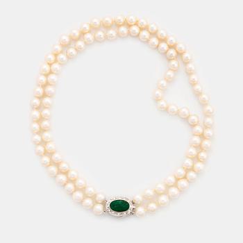 A two strand cultured pearl necklace with an 18K white gold and emerald clasp.