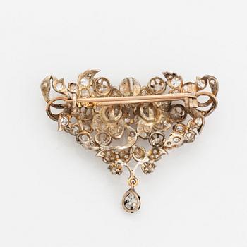 A silver brooch set with old-cut diamonds.