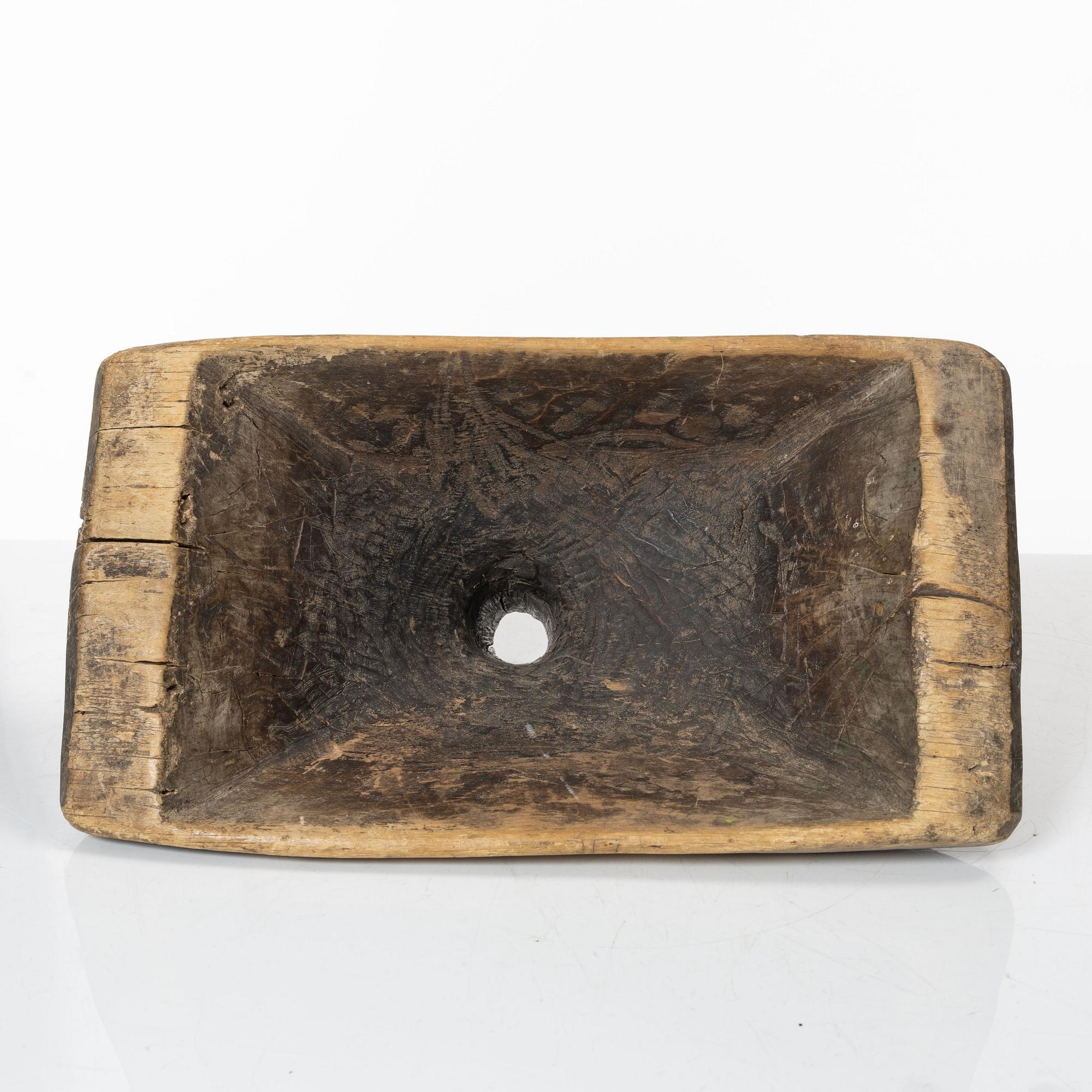 A Swedish carved wood milk funnel, dated 1687.