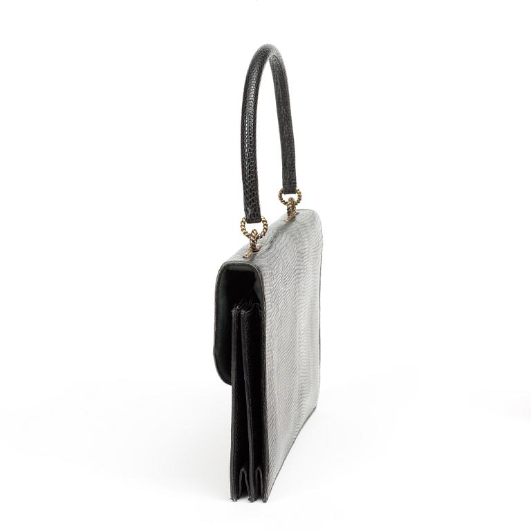 A black 1070s handbag by Hermès.