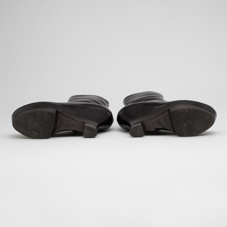 YVES SAINT LAURENT, a pair of brown leather wedge heeled platform boots.