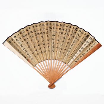 A Chinese fan signed Tang Xinyu, and dated to 1927 in an embroidered silk case.