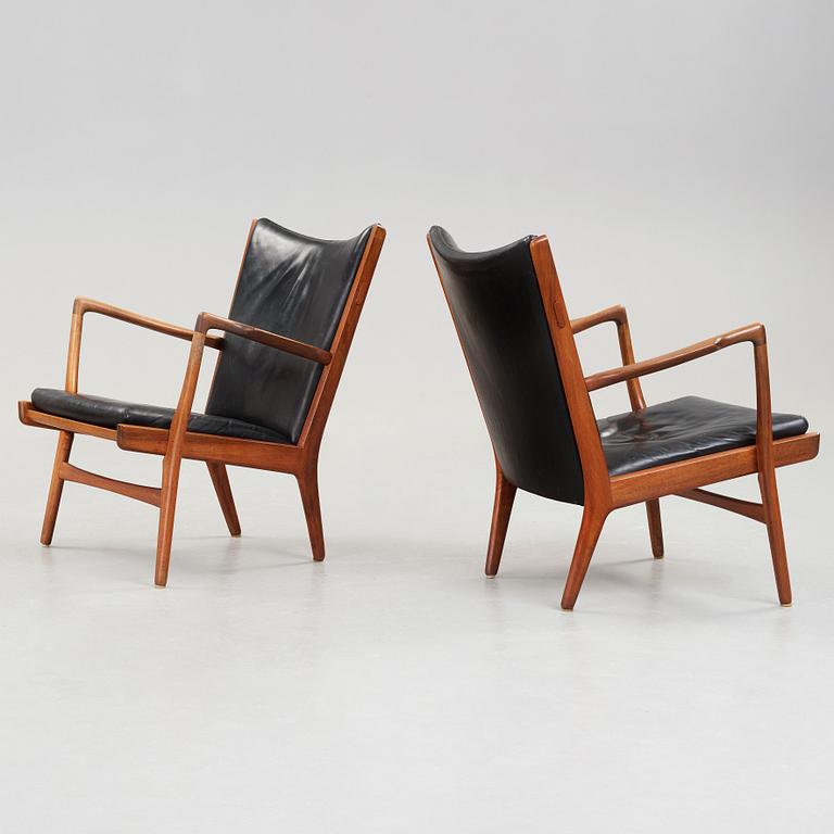 Hans J. Wegner, a pair of "AP16" teak and black leather armchairs, AP-stolen, Denmark 1950-60´s.