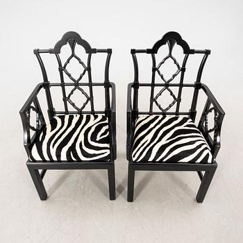 A pair of modern Eichholtz armchairs.