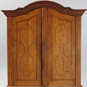 An oak rococo cabinet, mid 18th Century.