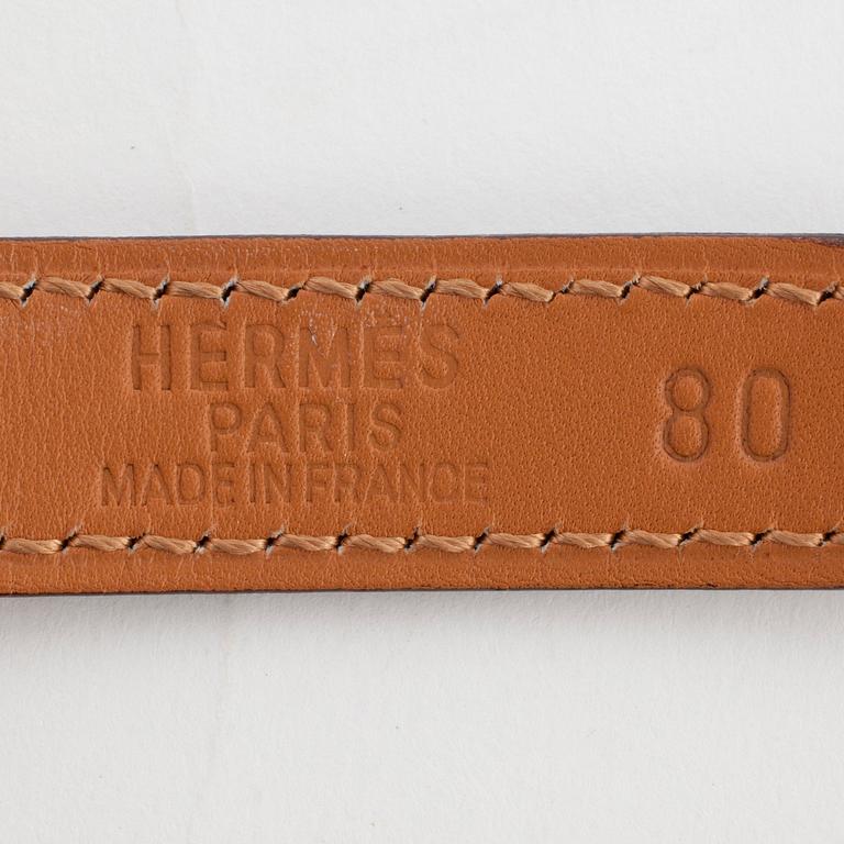 HERMÈS, a black leather belt.