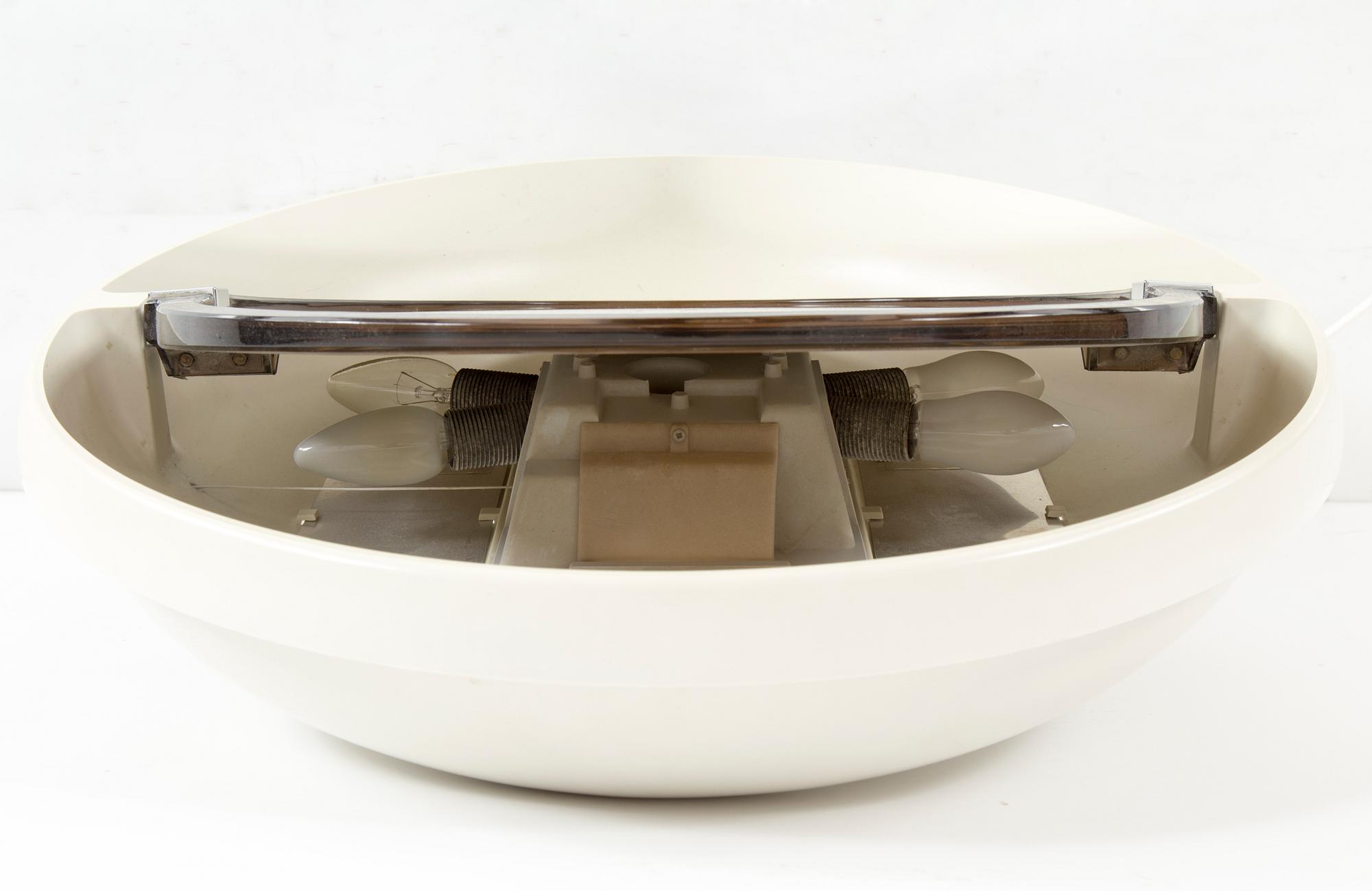 A "SPACE AGE" WALL MIRROR WITH LIGHT BY ALLIBERT, 1970s.