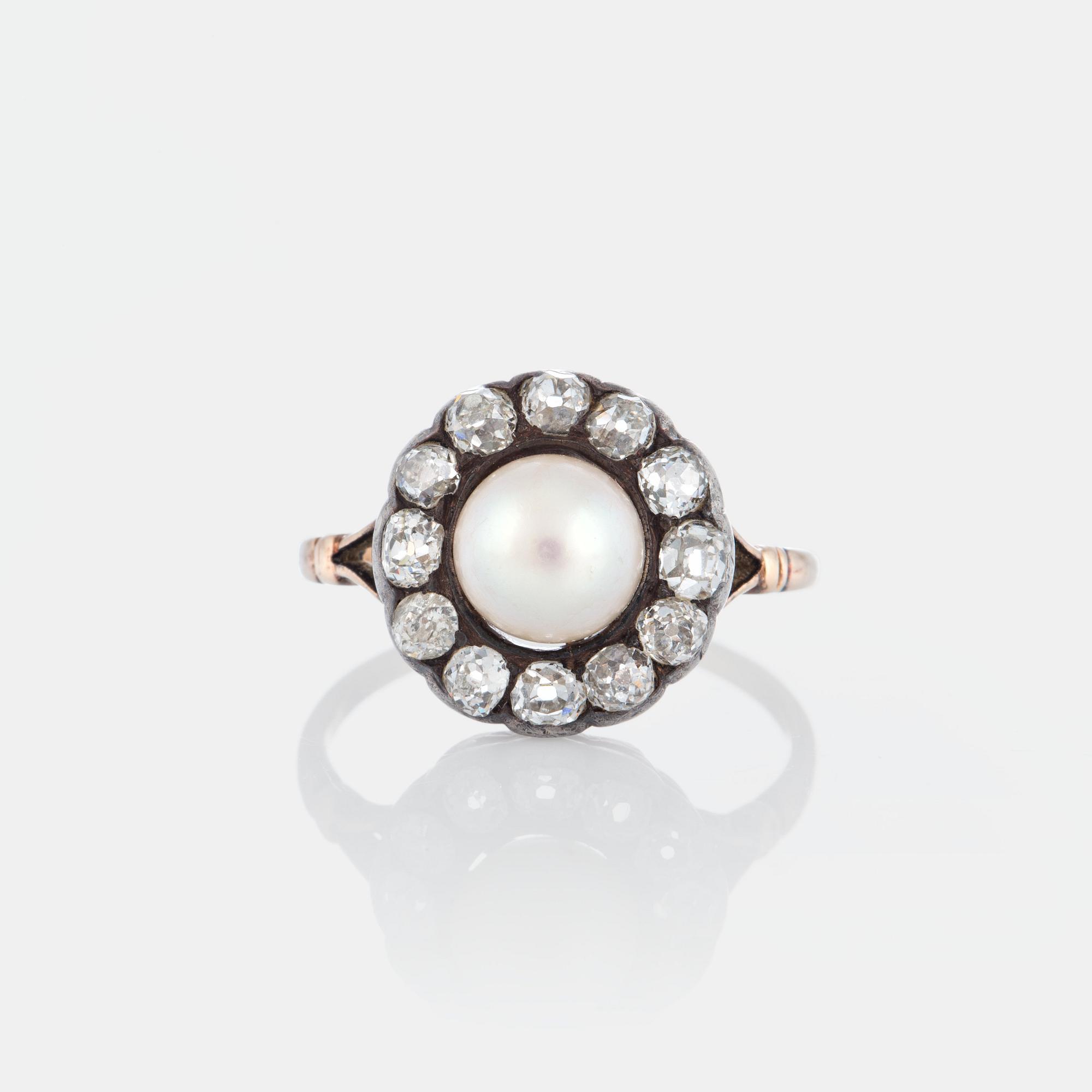 A pearl ring set with old-cut diamonds.