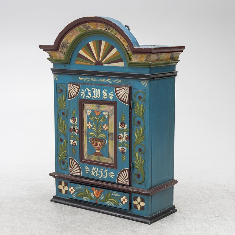 A 19th century folk art hanging cabinet.