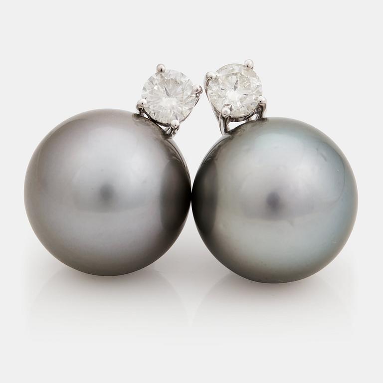 A pair of cultured Tahiti pearl and brilliant cut diamond earrings.