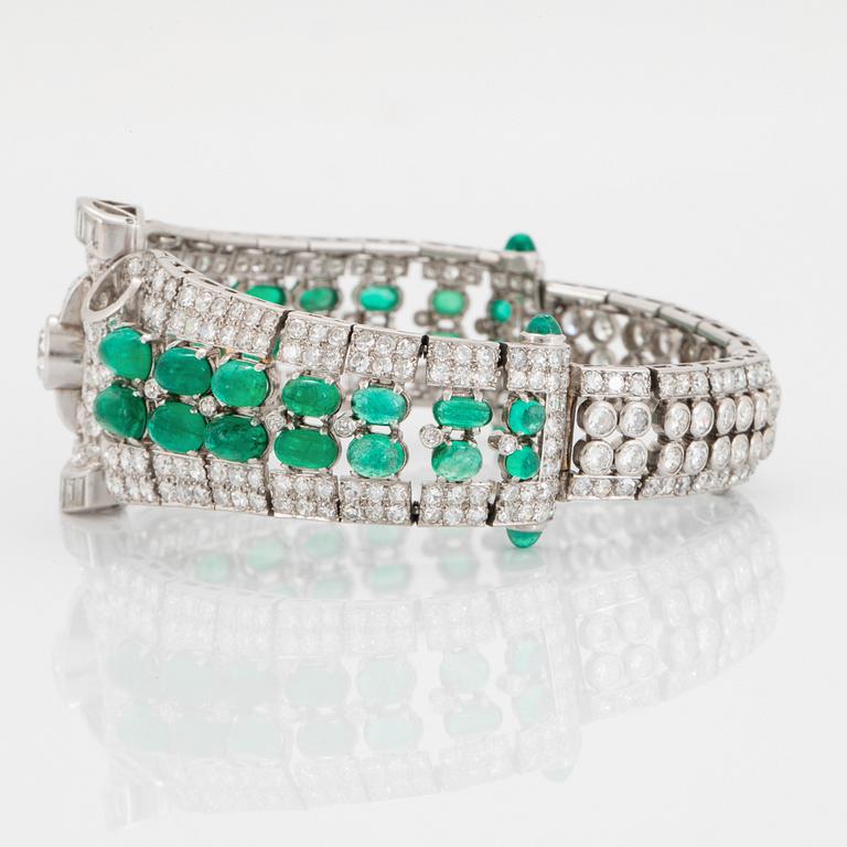 A platinum bracelet set with cabochon-cut emeralds and old-, eight- and baguette-cut diamonds.